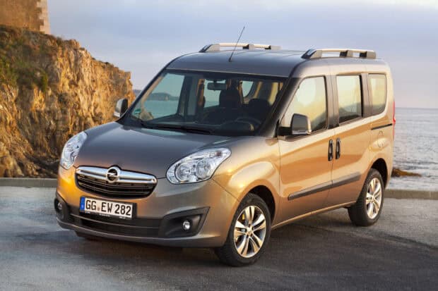 A silver Opel Combo is parked near the rocky coast at sunset showing its side and front views, 2K Desktop Wallpaper
