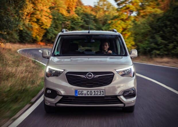 A man drives an Opel Combo through a winding road surrounded by autumn trees, HD Desktop Wallpaper