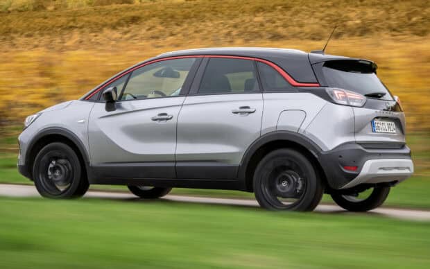 A silver Opel Crossland drives smoothly on a countryside road with blurred background, HD Desktop Wallpaper