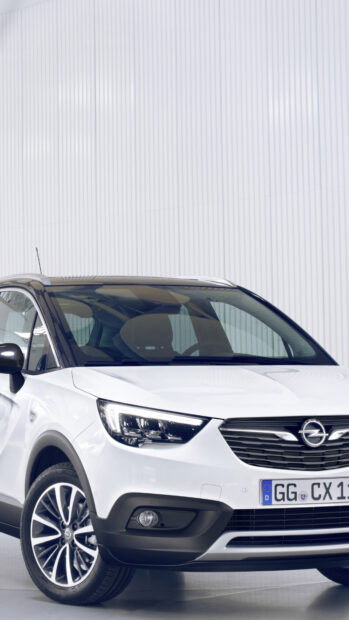 A white Opel Crossland is parked with a modern corrugated white wall behind it, 4K Mobile Wallpaper
