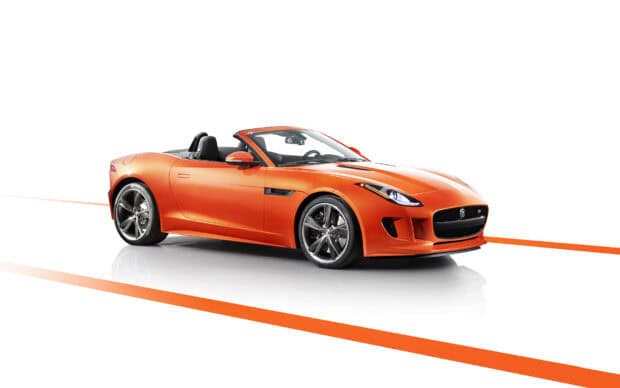 The Jaguar F Type is shown as an orange convertible sports car on a white background with orange lines, 2K Desktop Wallpaper