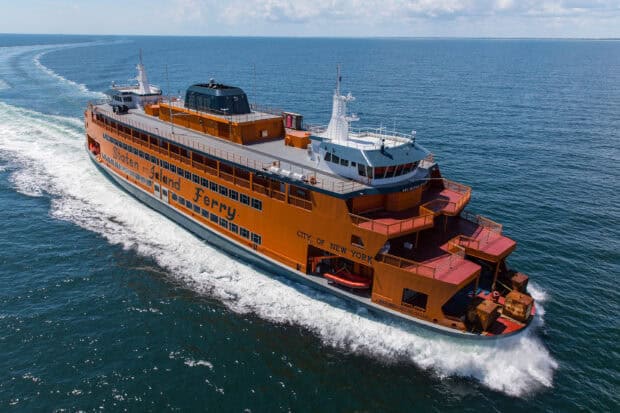 A large orange Staten Island ferry moves across the blue sea under a cloudy sky with the wake trailing behind, HD Desktop Wallpaper