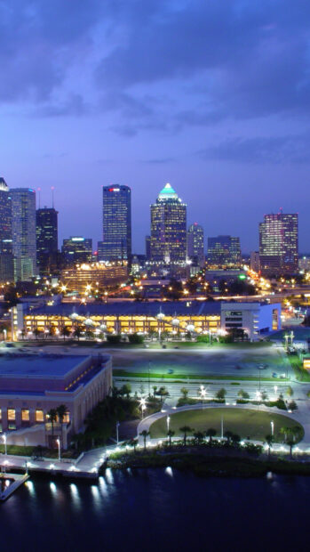 The Orlando skyline glows beautifully at dusk with illuminated buildings and waterfront views, HD Phone Wallpaper