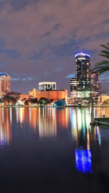 The Orlando city skyline reflects brightly on the calm water under a cloudy sky, HD Mobile Wallpaper