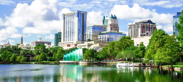 The Orlando skyline reflects beautifully on the lake with clear skies, 2K Desktop Wallpaper