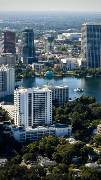 A clear view of Orlando city skyline with buildings and a lake in the foreground, HD Phone Wallpaper