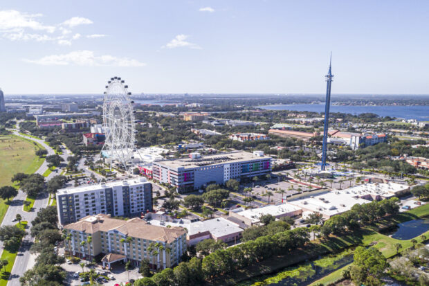 Aerial view of Orlando showcasing the observation wheel and cityscape under a clear blue sky, 2K Desktop Wallpaper