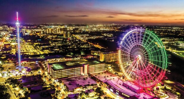 The Orlando cityscape features a vibrant ferris wheel lit in multiple colors during sunset, HD PC Wallpaper