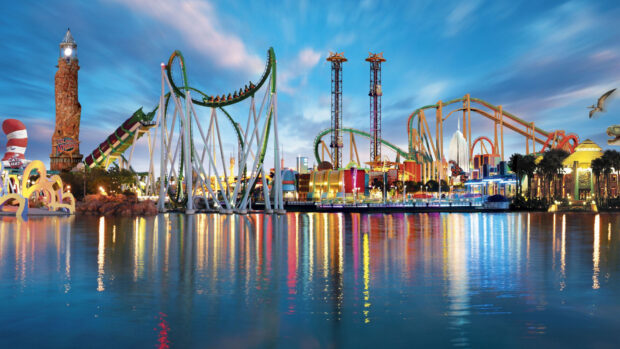 The Orlando Wallpapers show a colorful amusement park with rides and reflections on water, HD Desktop Wallpaper