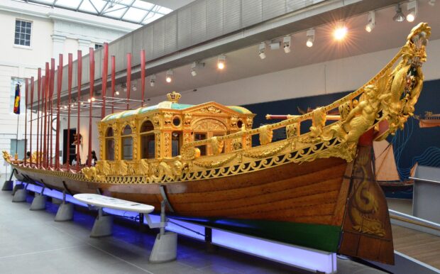 A detailed view of an ornate royal barge exhibited at the Maritime Museum showcasing historical craftsmanship, HD Desktop Wallpaper