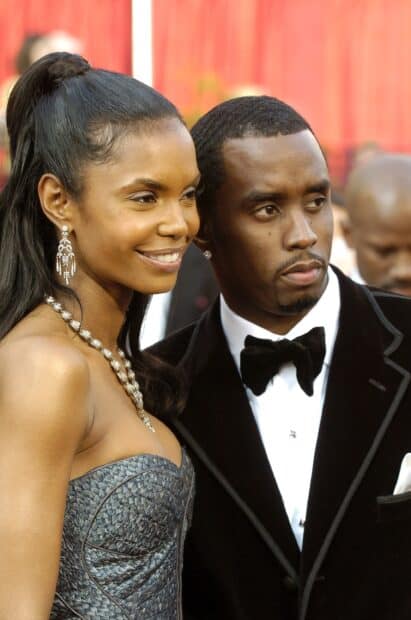 P Diddy Sean Combs stands next to a smiling woman dressed elegantly at a formal event, 2K Mobile Wallpaper