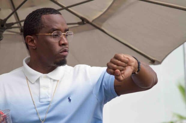 P Diddy Sean Combs looks at his wristwatch while standing outdoors under an umbrella, HD Desktop Wallpaper