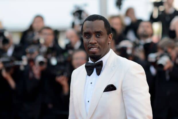 P Diddy Sean Combs is wearing a white suit and black bow tie at a public event, 2K Desktop Wallpaper