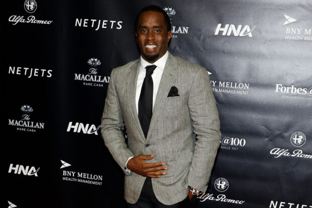 P Diddy Sean Combs stands confidently in a gray suit with a black tie, 2K Desktop Wallpaper