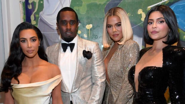 P Diddy Sean Combs stands with three women at an event in elegant attire, HD Desktop Wallpaper