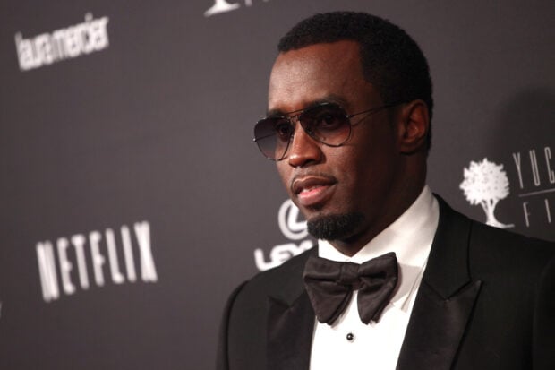 P Diddy Sean Combs wears a black tuxedo and sunglasses at a formal event, 2K Desktop Wallpaper