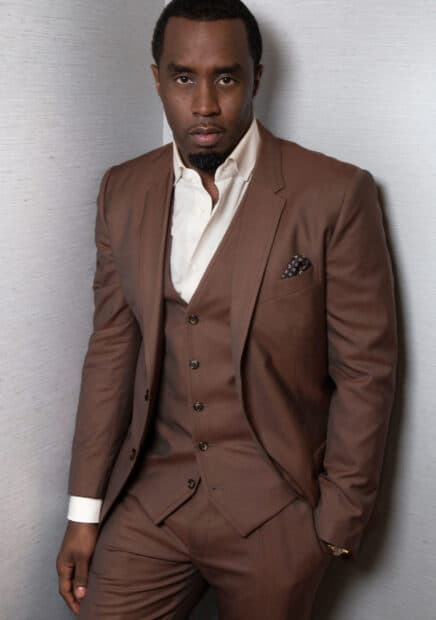 P Diddy Sean Combs stands confidently wearing a brown suit and white shirt, HD Mobile Wallpaper