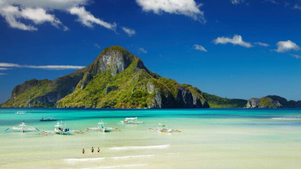 A beautiful view of Palawan with turquoise water and boats near the shore, HD Desktop Wallpaper