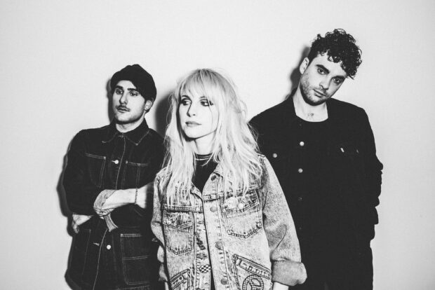 The Paramore band members stand together looking thoughtful in black and white, 2K Desktop Wallpaper