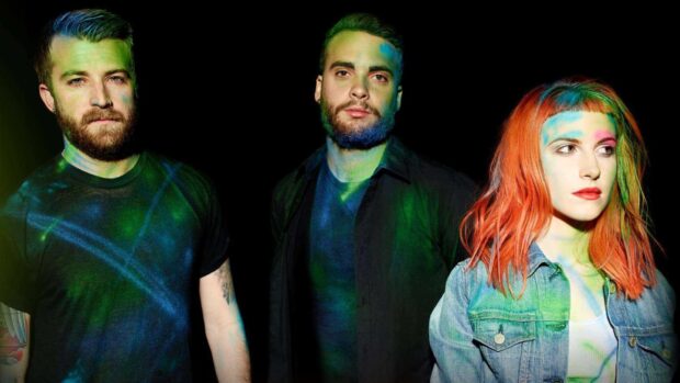 Paramore band members stand with colorful light effects on them, HD Desktop Wallpaper