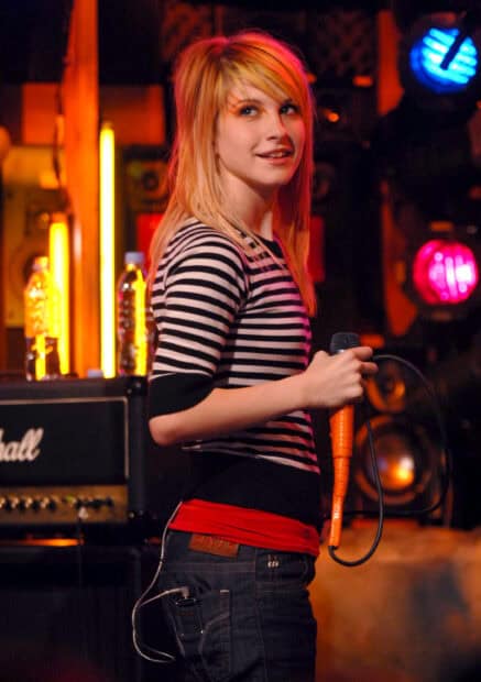 The musician holds a microphone on stage during a live Paramore Wallpapers concert, 2K Desktop Wallpaper