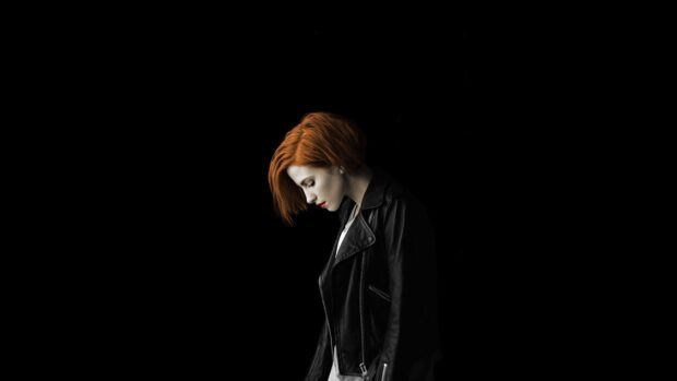 The Paramore lead singer stands against a black background with red hair, HD Desktop Wallpaper