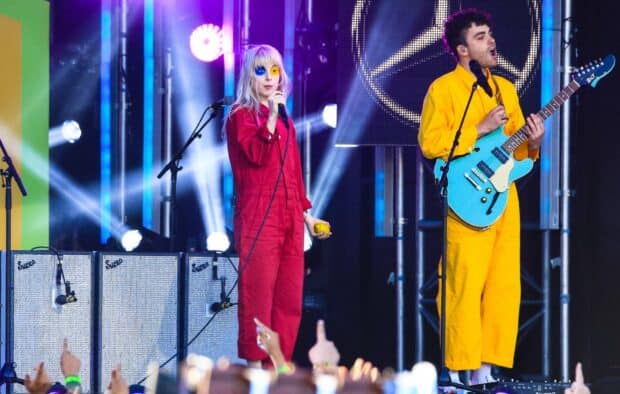 A Paramore band member sings while another plays guitar on stage, HD Desktop Wallpaper