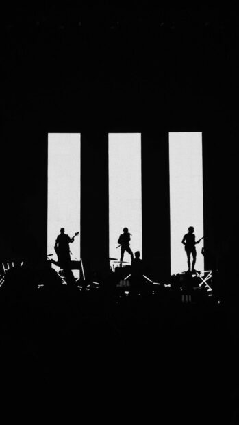 The Paramore band performs on stage with bright lights, HD Phone Wallpaper