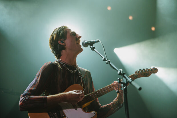 A Parcels Band member passionately sings and plays guitar on stage, HD Desktop Wallpaper (1)