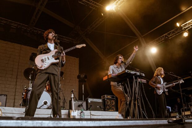 The Parcels band performing with guitar and keyboard during a concert, 2K Desktop Wallpaper