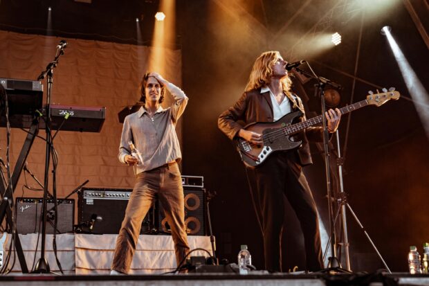 Two Parcels Band members performing during a concert on stage, 2K Desktop Wallpaper