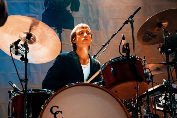 A drummer from Parcels band focused while playing drums on stage, 2K Desktop Wallpaper