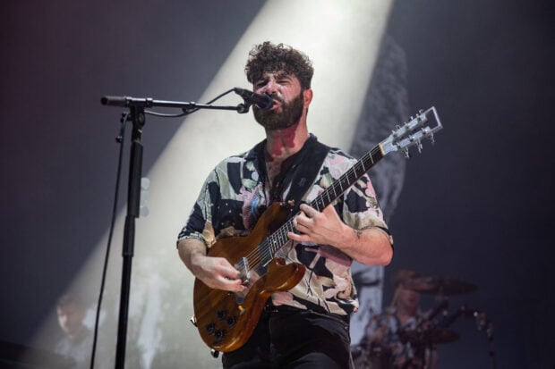A Foals band guitarist passionately sings and plays in a live concert, HD Desktop Wallpaper