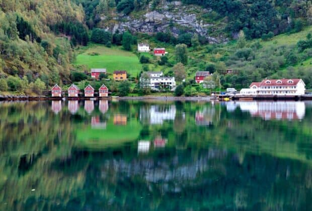 A peaceful Norwegian fjord village with colorful houses reflected in the calm water, HD Desktop Wallpaper