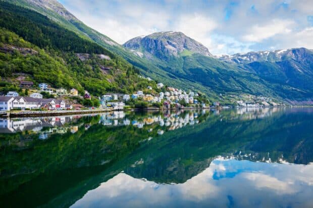 A peaceful village by green mountains reflects on calm water in Norwegian fjords wallpapers, HD Desktop Wallpaper