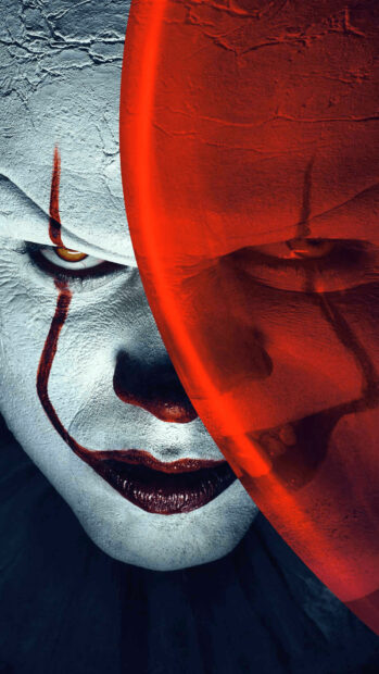 A close up of Pennywise holding a glowing red balloon from Warner Bros wallpapers, HD Phone Wallpaper