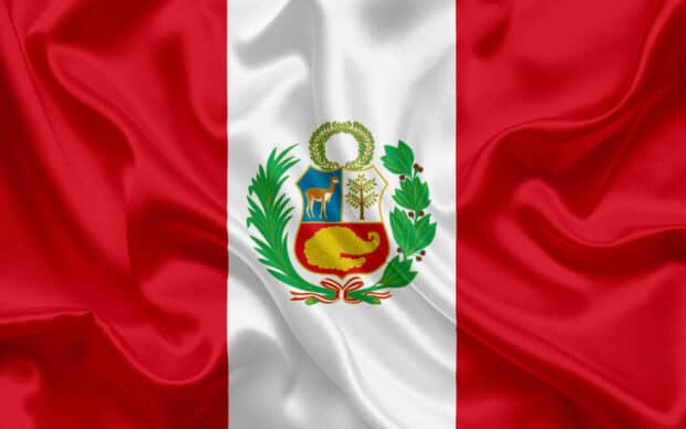 The Peru flag with the national emblem displayed on fabric, 2K Desktop Wallpaper