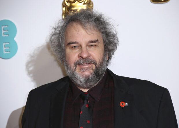 Peter Jackson wears a black suit with a patterned tie and a gray beard, 2K Desktop Wallpaper