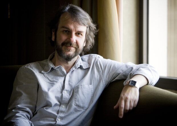 Peter Jackson wallpapers shows a relaxed man with a beard sitting by a window in casual wear, 2K Desktop Wallpaper