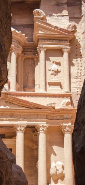 The image shows Petra Jordan's ancient carved pillars and stone facade, HD Mobile Wallpaper