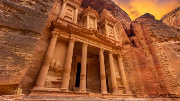 The ancient rock facade of Petra Jordan stands carved in sandstone cliffs, HD Desktop Wallpaper