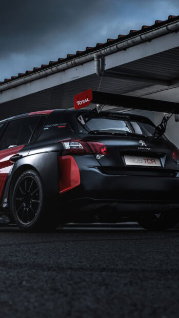 A sleek Peugeot 308 car with sporty design and a large rear spoiler, 4K Phone Wallpaper