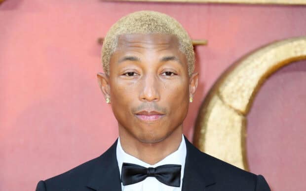 Pharrell Williams is wearing a black tuxedo and bow tie at an event, HD Desktop Wallpaper