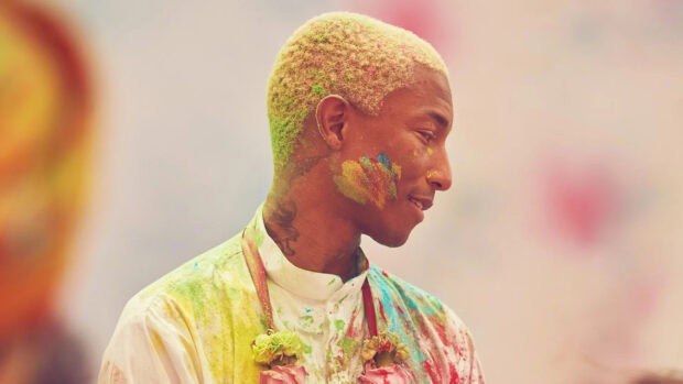 Pharrell Williams is seen with colorful powder on his face and clothing, HD Desktop Wallpaper