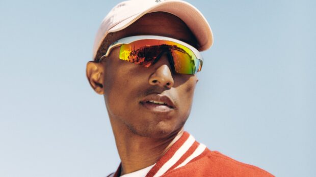 Pharrell Williams wearing reflective sunglasses and a cap under clear sky, 4K Desktop Wallpaper