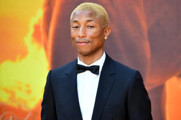 Pharrell Williams in a black tuxedo with a bow tie posing at the event, 2K Desktop Wallpaper