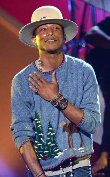 Pharrell Williams wearing a holiday sweater and large hat while performing on stage, HD Mobile Wallpaper