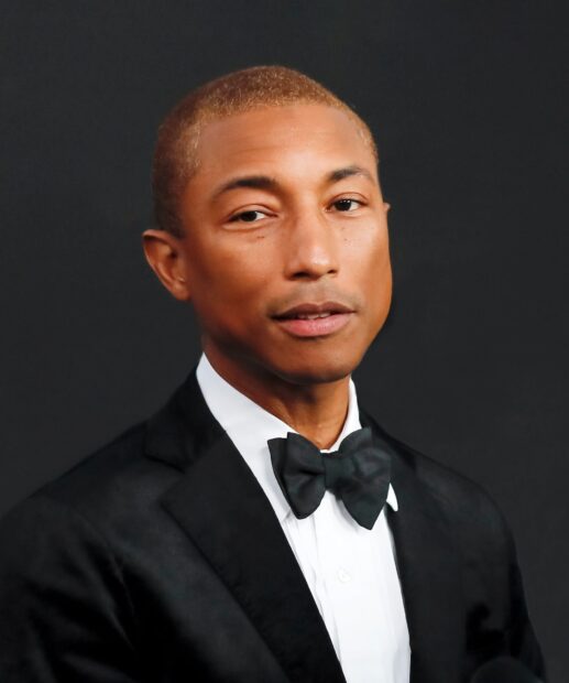 Pharrell Williams appears in a formal black tuxedo with bow tie against a dark background, HD Desktop Wallpaper