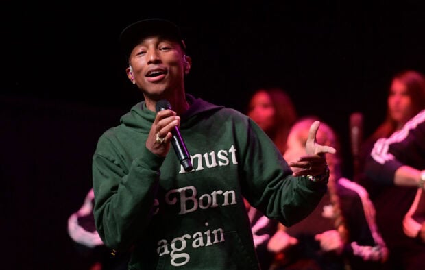 Pharrell Williams is singing and holding a microphone during a live performance, HD Desktop Wallpaper