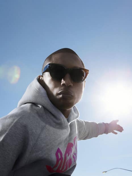 Pharrell Williams wears sunglasses and a hoodie under a clear blue sky, HD Mobile Wallpaper